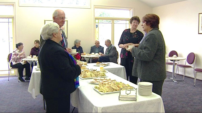 Mourners conversing in Function Room